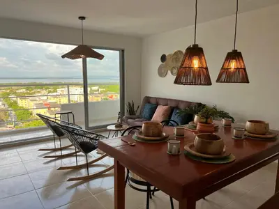 a living room with a wooden table and chairs at Boho style house in Cartagena de Indias