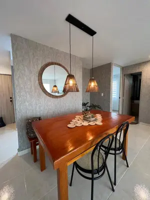 a dining room with a wooden table and a mirror at Boho style house in Cartagena de Indias