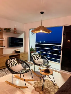 a living room with two chairs and a large window at Boho style house in Cartagena de Indias