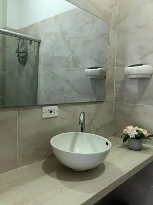 a bathroom with a white sink and a mirror at Hermoso Apartamento en Caribe Campestre in Coveñas