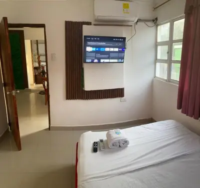 a room with a bed and a tv on the wall at Hostal Viva Mar in Cartagena de Indias