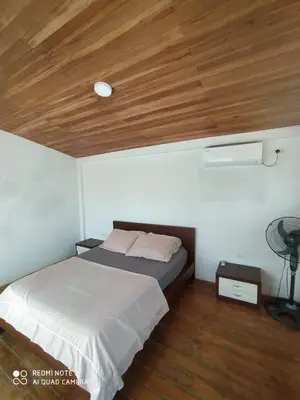 a bedroom with a bed and a wooden ceiling at cabañas Brisas y Perla by AMAUNA in Moñitos
