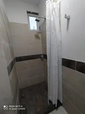 a shower with a shower curtain in a bathroom at cabañas Brisas y Perla by AMAUNA in Moñitos