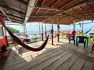 a hammock on the deck of a boat at Hostal Paraiso in Isla Mucura