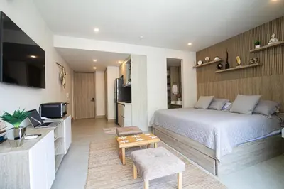 a bedroom with a bed and a living room at Apartamento en Morros Zoe con acceso directo al mar en Cartagena in Cartagena de Indias