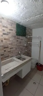 a bathroom with a sink and a stone wall at Encantadora casa con ambiente guajiro #3 in Barranquilla