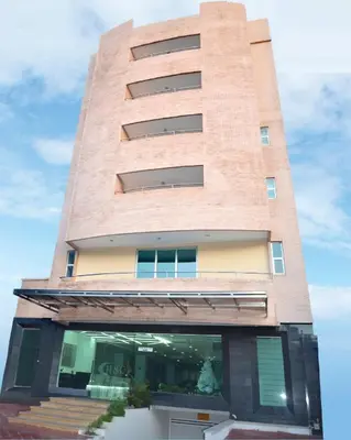 a tall brick building with a window at Hotel Suite Continental in Barranquilla