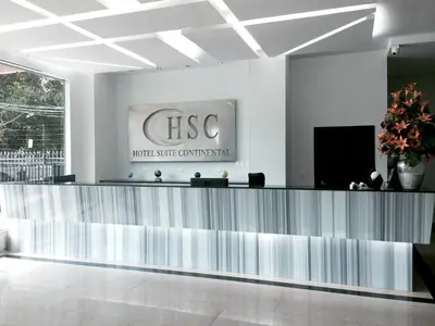 a lobby with a reception desk in a building at Hotel Suite Continental in Barranquilla