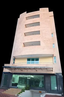 a tall brick building with a window at Hotel Suite Continental in Barranquilla