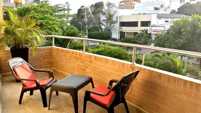 three chairs and a table on a balcony at Hotel Suite Continental in Barranquilla