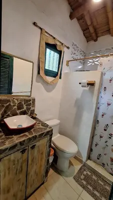 a bathroom with a toilet and a shower and a sink at Eco-Hotel Chevere Beach in Puebloviejo