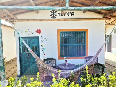 a house with a hammock in front of it at Eco-Hotel Chevere Beach in Puebloviejo