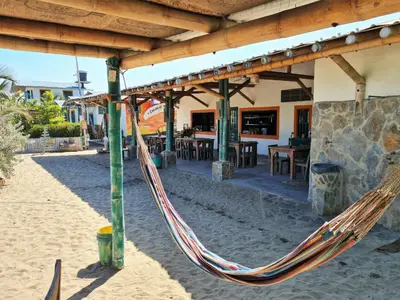 a hammock hanging from awning outside a restaurant at Eco-Hotel Chevere Beach in Puebloviejo