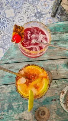 a drink in a bowl and an orange on a table at Eco-Hotel Chevere Beach in Puebloviejo