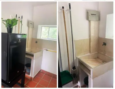 a kitchen with a black refrigerator and a sink at Apartamentos Sol de Coveñas TI in Coveñas