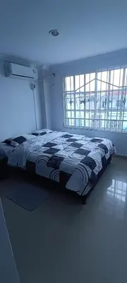 a bed in a bedroom with a blue light at Apto los Almendros in Cartagena de Indias