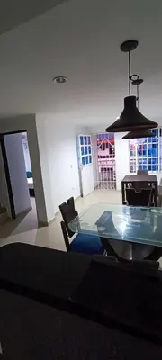 a dining room with a glass table and chairs at Apto los Almendros in Cartagena de Indias