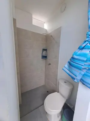a bathroom with a toilet and a shower at Don Mathias # 2, Coveñas - Apartamento in Coveñas