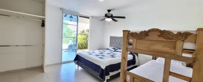 a bedroom with a bed and a ceiling fan at Extraordinaria Casa Finca Piscina AA in Sabanalarga