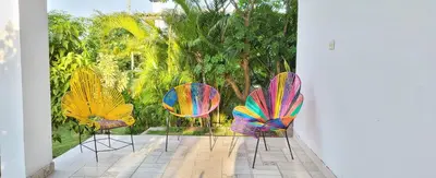 a group of chairs sitting on a patio at Extraordinaria Casa Finca Piscina AA in Sabanalarga