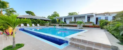 a swimming pool in front of a house at Extraordinaria Casa Finca Piscina AA in Sabanalarga