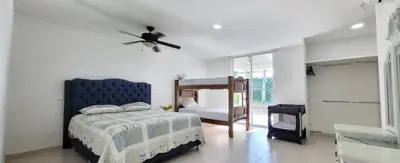 a bedroom with a bed and a ceiling fan at Extraordinaria Casa Finca Piscina AA in Sabanalarga