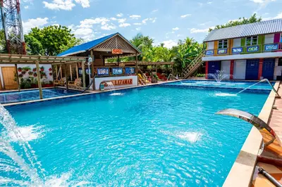 a pool at a resort with a fountain at Hotel Isla Lizamar in Isla Grande