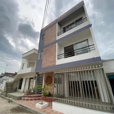 a house with a fence in front of it at Aparta Suites Balcones de la Sierra in Fundación