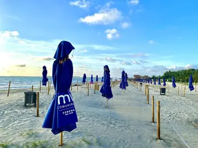 a group of blue umbrellas on a beach at Morros Zoe - Beautiful Apartment on Manzanillo Beach in Cartagena de Indias