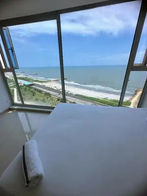 a room with a bed and a view of the ocean at Penthouse vista panoramica frontal al mar 450 mts2 in Cartagena de Indias