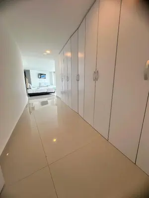 a hallway with white cabinets in a room at Penthouse vista panoramica frontal al mar 450 mts2 in Cartagena de Indias