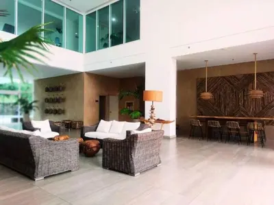 a living room with wicker chairs and a bar at Moderno 3 hab con la mejor Vista en playa dormida Santa Marta in Santa Marta