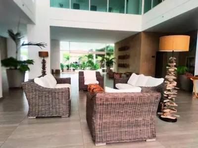 a lobby with couches and chairs in a building at Moderno 3 hab con la mejor Vista en playa dormida Santa Marta in Santa Marta