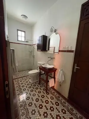 a bathroom with a toilet and a sink at Casa Blanca María Barranquilla - Authentic republican house in Barranquilla