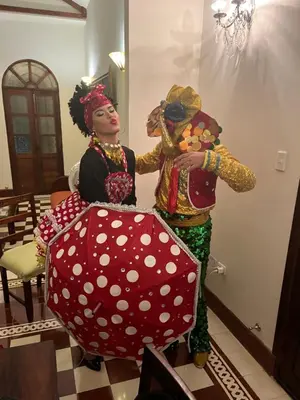 a woman in a costume holding a large polka dot umbrella at Casa Blanca María Barranquilla - Authentic republican house in Barranquilla