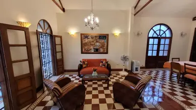 a living room with a couch and a table at Casa Blanca María Barranquilla - Authentic republican house in Barranquilla