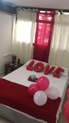 a bed with pink and white balloons on it at Guacamayas in Santa Marta