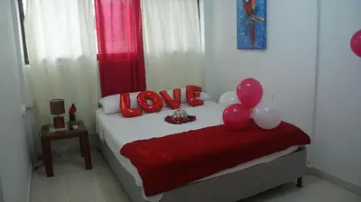 a bedroom with a bed with balloons on it at Guacamayas in Santa Marta