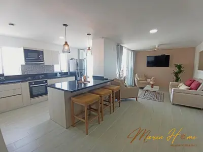 a large kitchen and living room with a counter top at 2BR Oceanfront Apartment - Direct Beach Access - Modern and Spacious - 6th Floor in Cartagena de Indias
