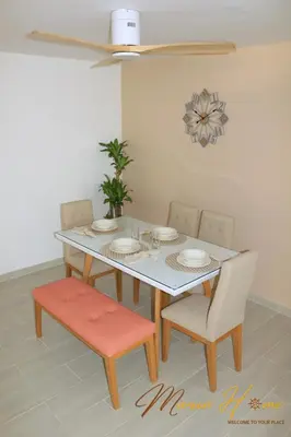 a dining room with a table and chairs and a ceiling fan at 2BR Oceanfront Apartment - Direct Beach Access - Modern and Spacious - 6th Floor in Cartagena de Indias