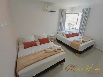 a bedroom with two beds and a window at 2BR Oceanfront Apartment - Direct Beach Access - Modern and Spacious - 6th Floor in Cartagena de Indias
