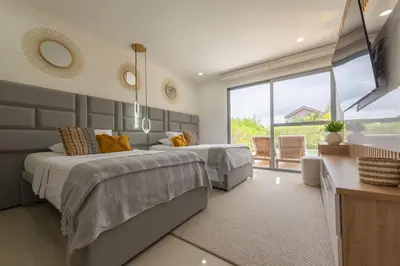 a bedroom with two beds and a large window at Lujoso Apartamento Con Salida Directa A La Playa Edificio Morros Eco in Cartagena de Indias
