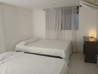 a bedroom with two beds and a window and a dresser at @casa_grace Bienvenidos! in Cartagena de Indias