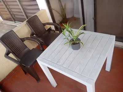 a white table with two chairs and a potted plant at @casa_grace Bienvenidos! in Cartagena de Indias