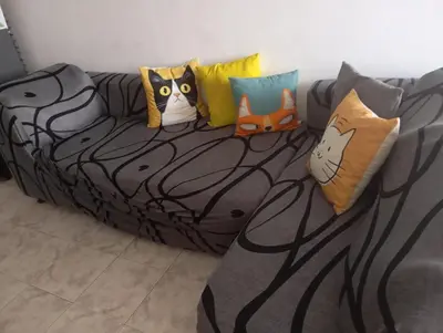 a couch with several pillows on top of it at @casa_grace Bienvenidos! in Cartagena de Indias