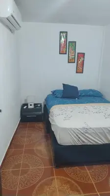 a bedroom with a bed in a room at Apartamento a unos pasos de la playa in Cartagena de Indias