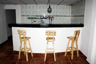 a kitchen with two wooden stools at a counter at Apartamento a unos pasos de la playa in Cartagena de Indias