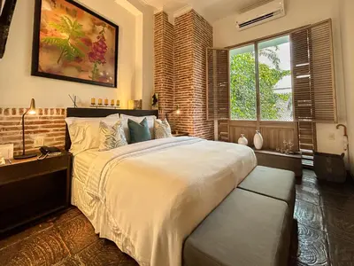 a bedroom with a large bed and a window at Casa Belle Cartagena Hotel Boutique in Cartagena de Indias