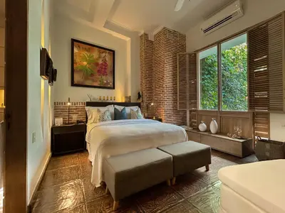 a bedroom with a large bed and a large window at Casa Belle Cartagena Hotel Boutique in Cartagena de Indias