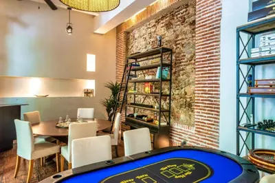 a restaurant with a ping pong table and a brick wall at Casa Belle Cartagena Hotel Boutique in Cartagena de Indias